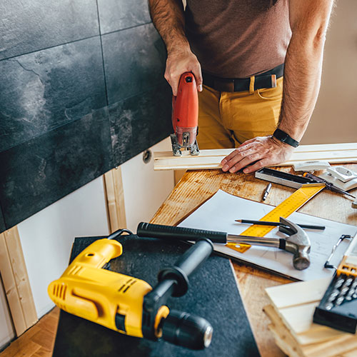 Man Working on a House Fixer-Upper