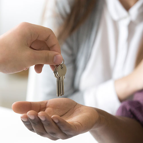 Real Estate Agent Giving New Home Buyer House Keys